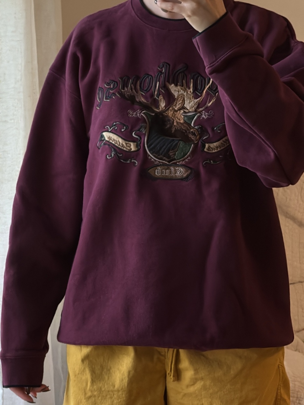 Maroon fleece crewneck sweatshirt with moose embroidery.